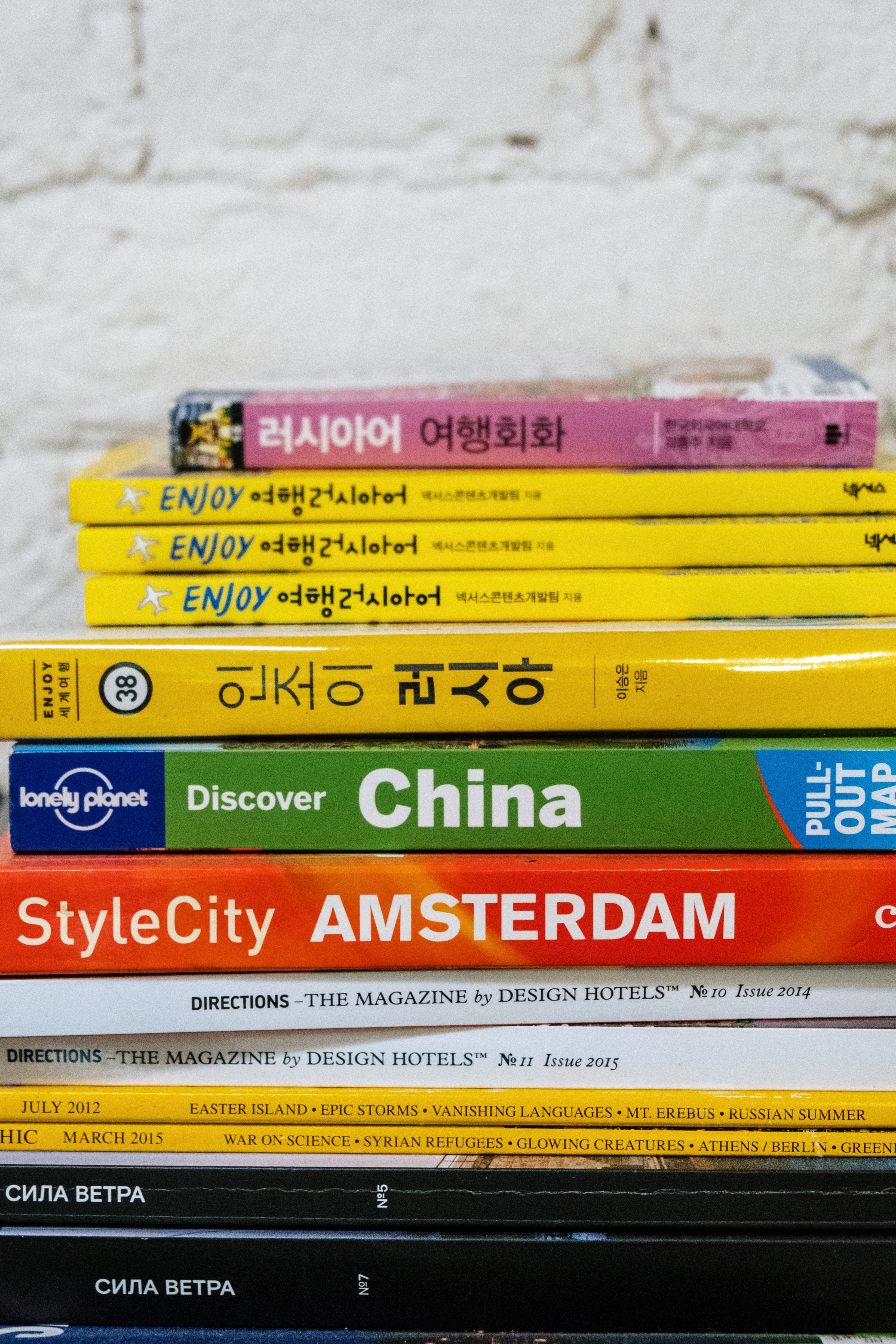 Colorful stack of travel guides and language books for global explorers